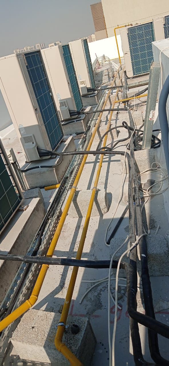 Precision copper piping and wiring for rooftop AC units in Dubai