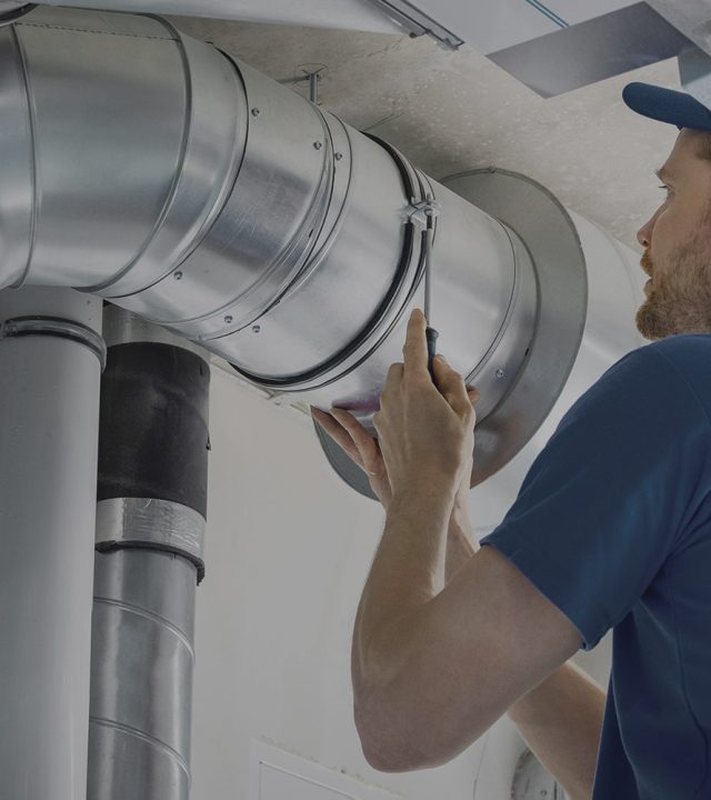Professional technician repairing AC ventilation and ductwork system in Dubai